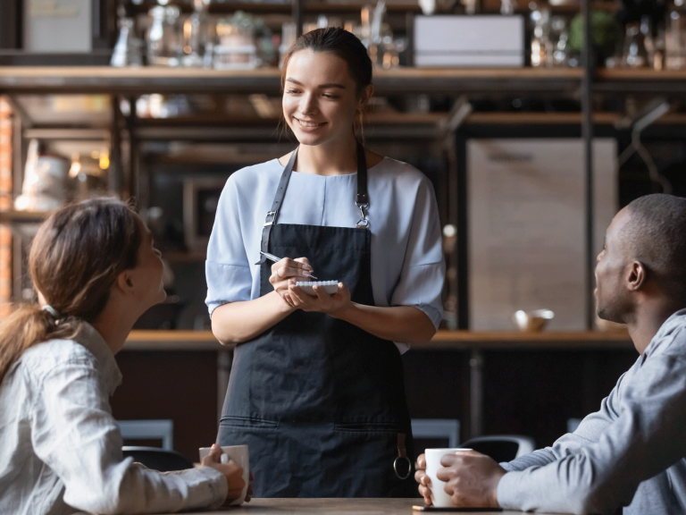 a waitress taking a couple's order