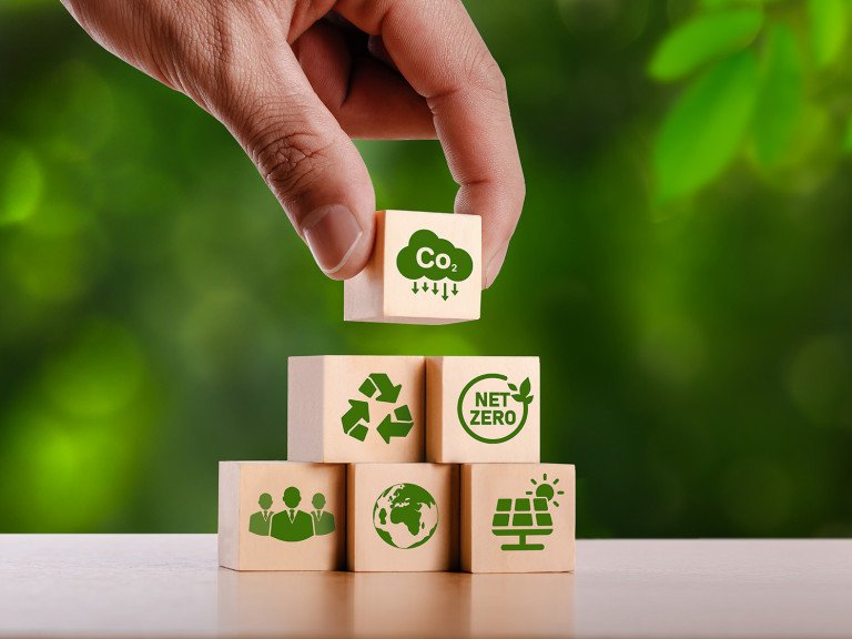 concept of carbon credit reducing carbon emissions Zero net greenhouse gas emissions target Carbon credits to invest in sustainable businesses green climate investment wooden block with green icon