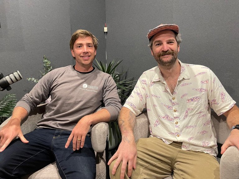 Two businesses people in podcast studio smiling at camera. Tom Hiney from SunButter Skincare. Sam Keck from Commonfolk Coffee.